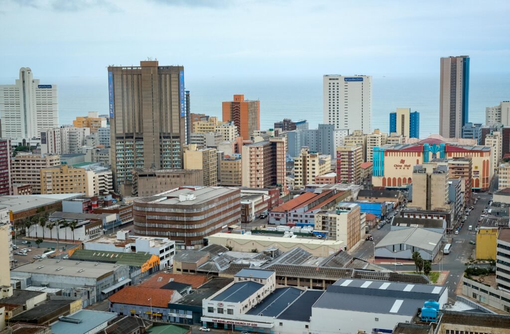 Panoramic view of Durban's modern skyline showcasing high-rise buildings and ocean backdrop.